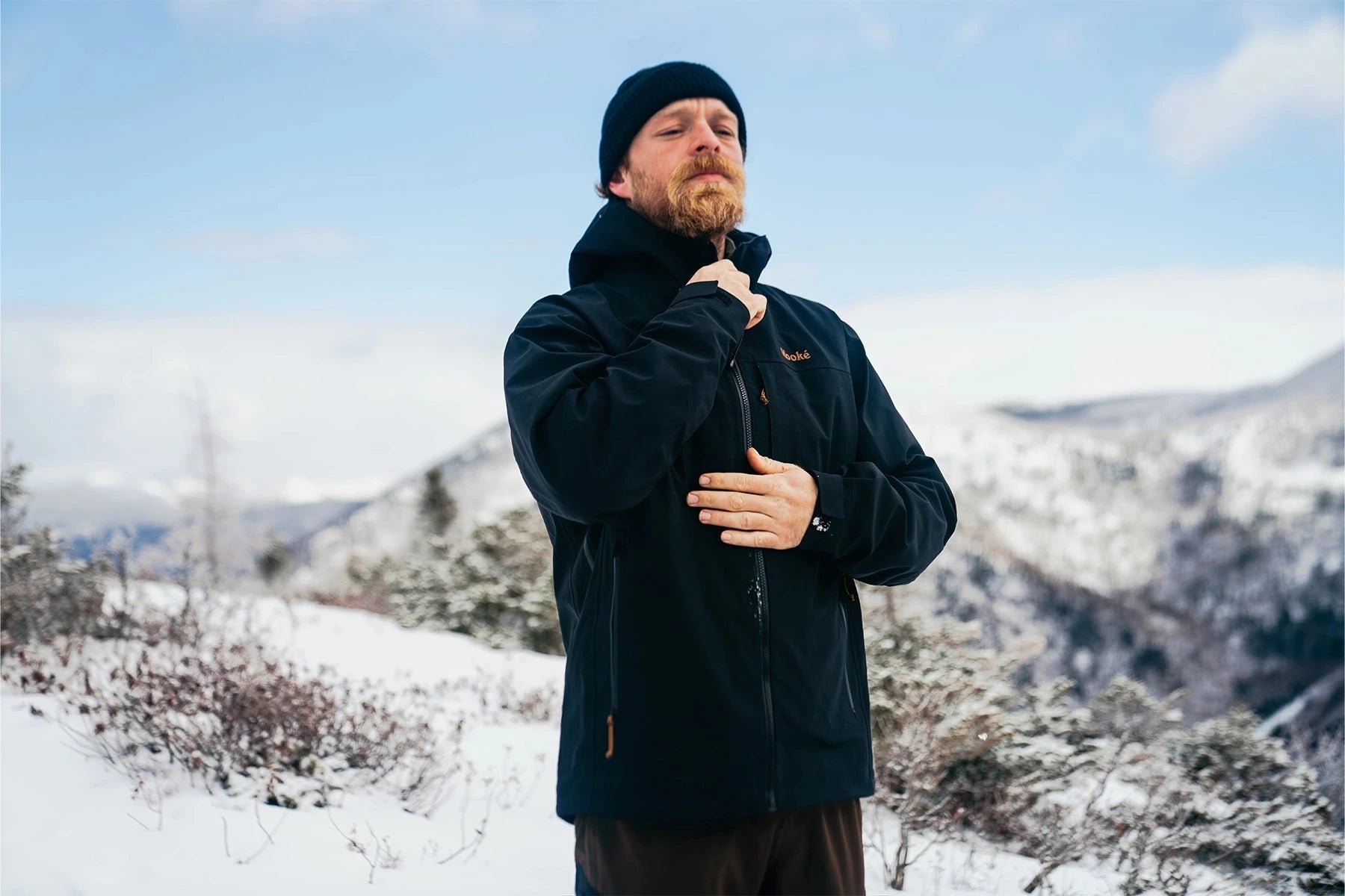 man hanging jackets on clothes line outside