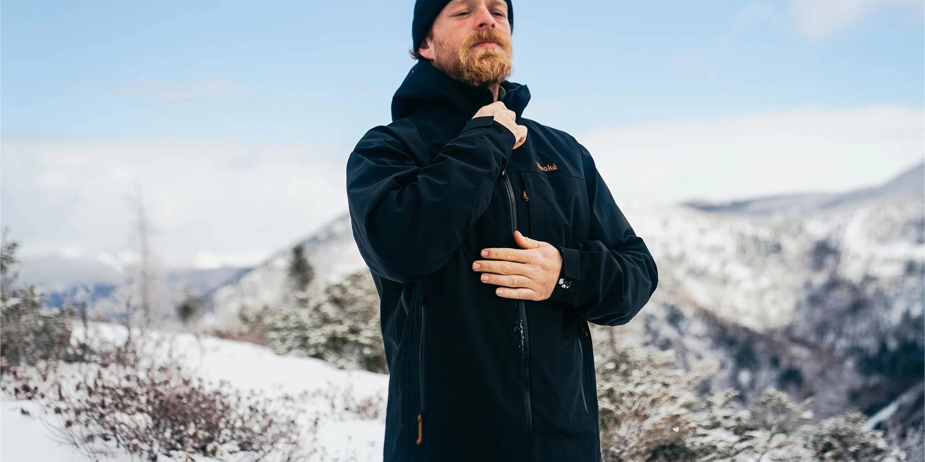 man hanging jackets on clothes line outside